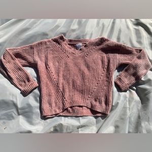 A small pink fuzzy sweater